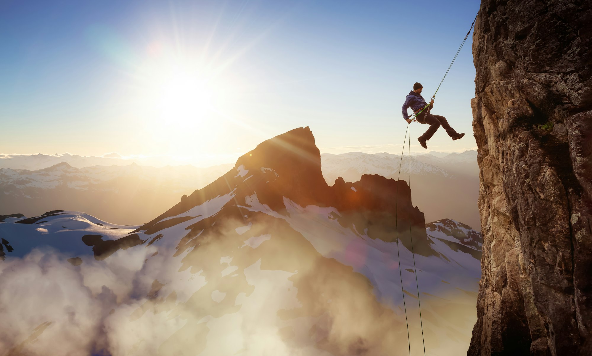 Epic Adventurous Extreme Sport Composite of Rock Climbing Man Rappelling from a Cliff