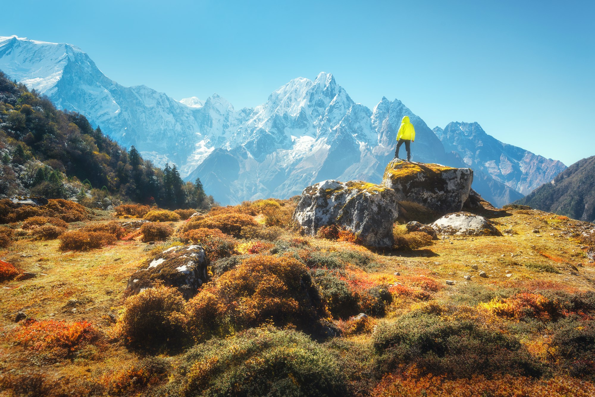 Standing man on the stone and looking on amazing Himalayan mount